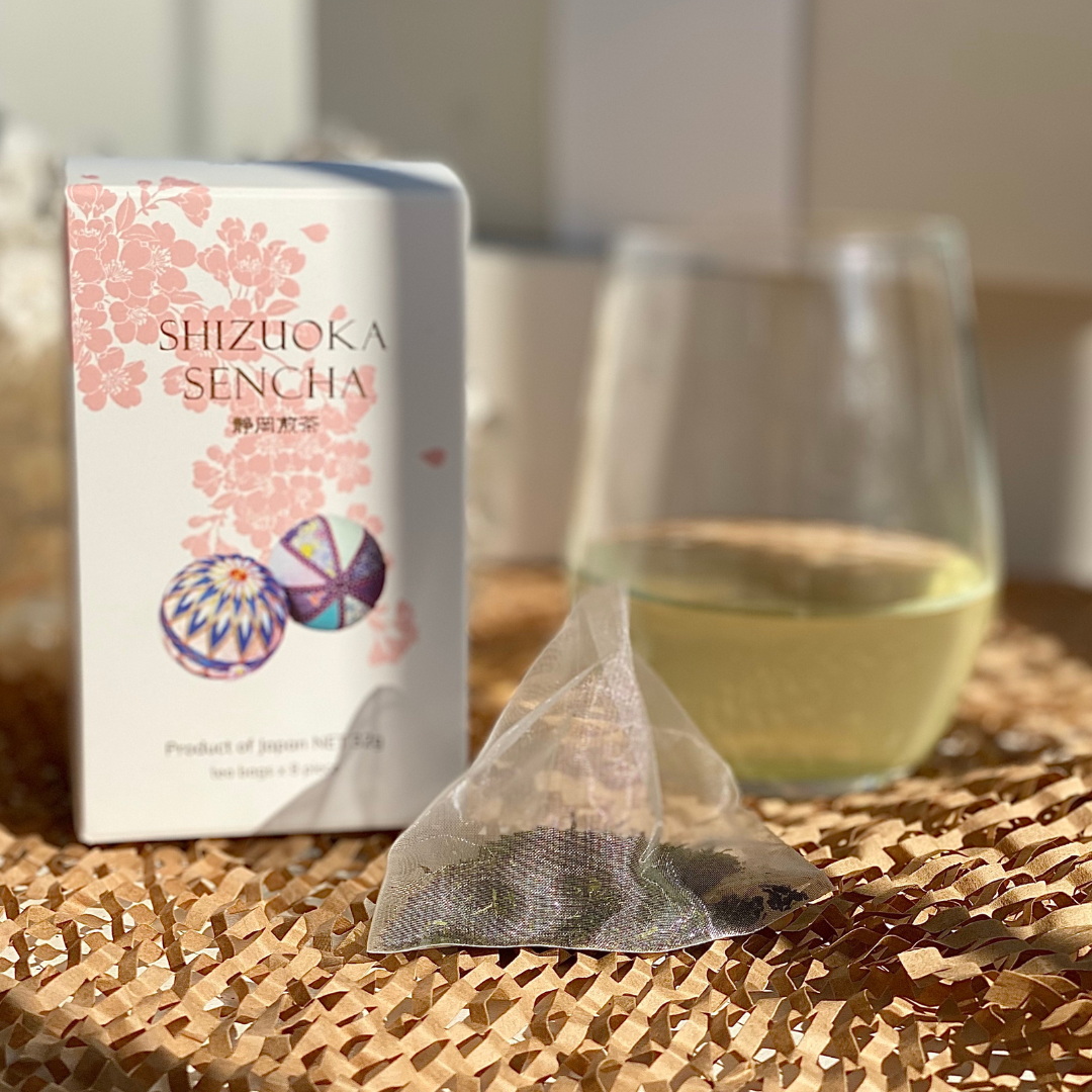 Shizuoka sencha box with a glass of brewed tea.