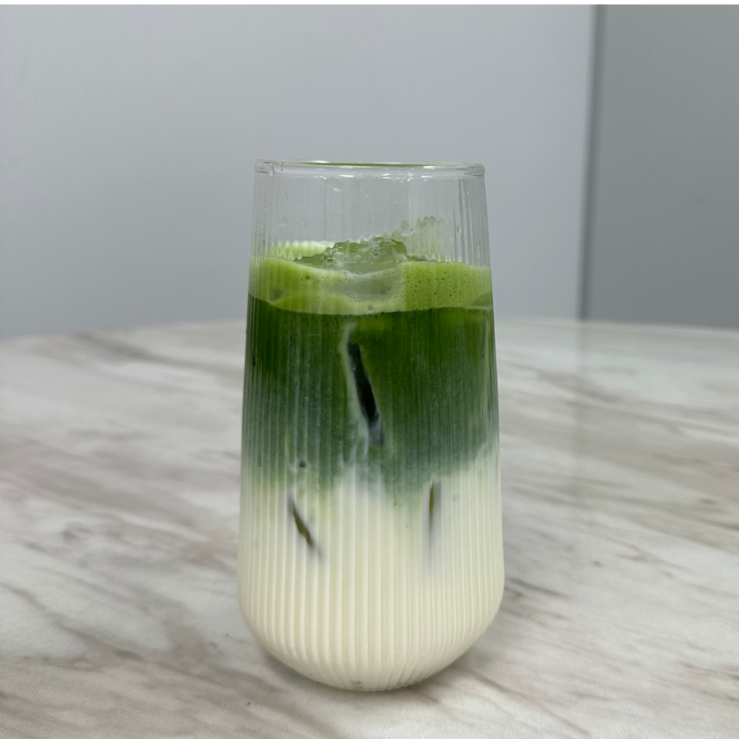 Glass with layered matcha latte