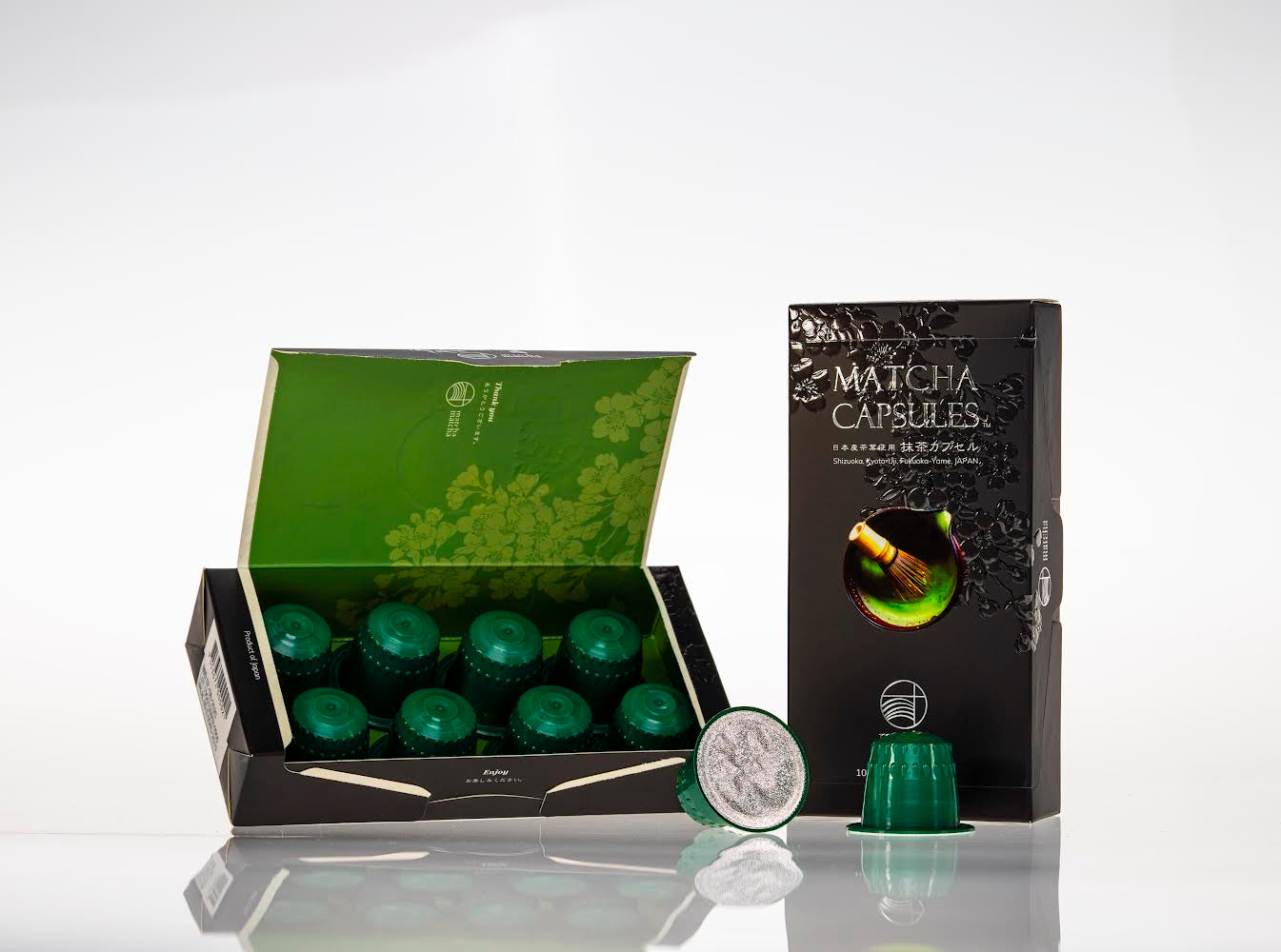 Opened matcha capsule packaging with green tea illustration on a white background