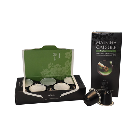 Opened matcha capsule packaging with green tea illustration on a white background